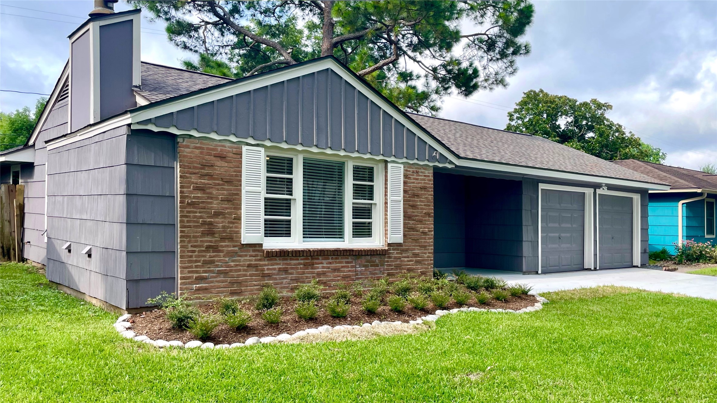 5905 Darnell Street Houston, TX 77074 - Photo 4 of 34 a view of brick house with a yard potted plants and a table