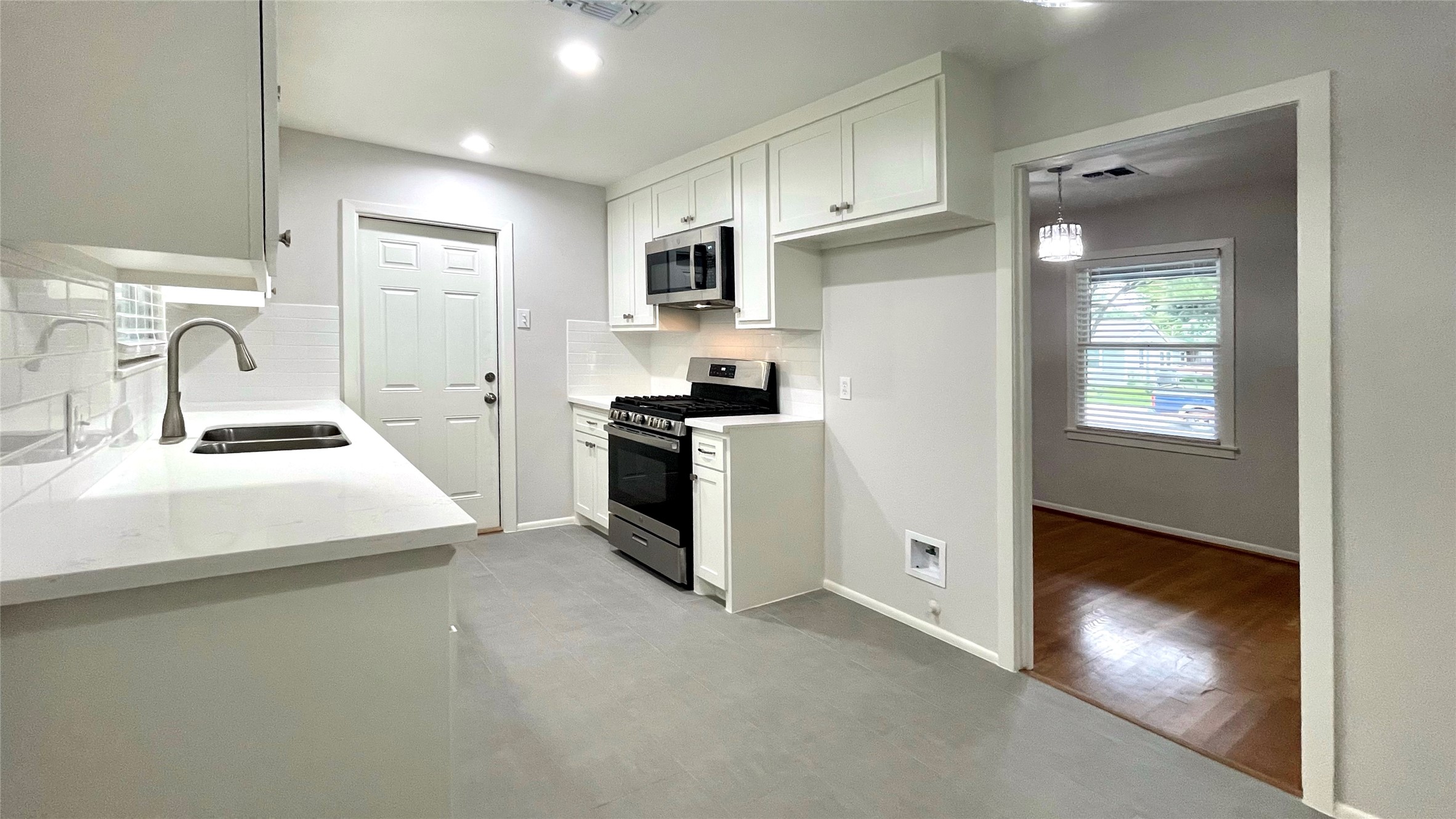 5905 Darnell Street Houston, TX 77074 - Photo 5 of 34 a kitchen that has a sink stainless steel appliances and cabinets