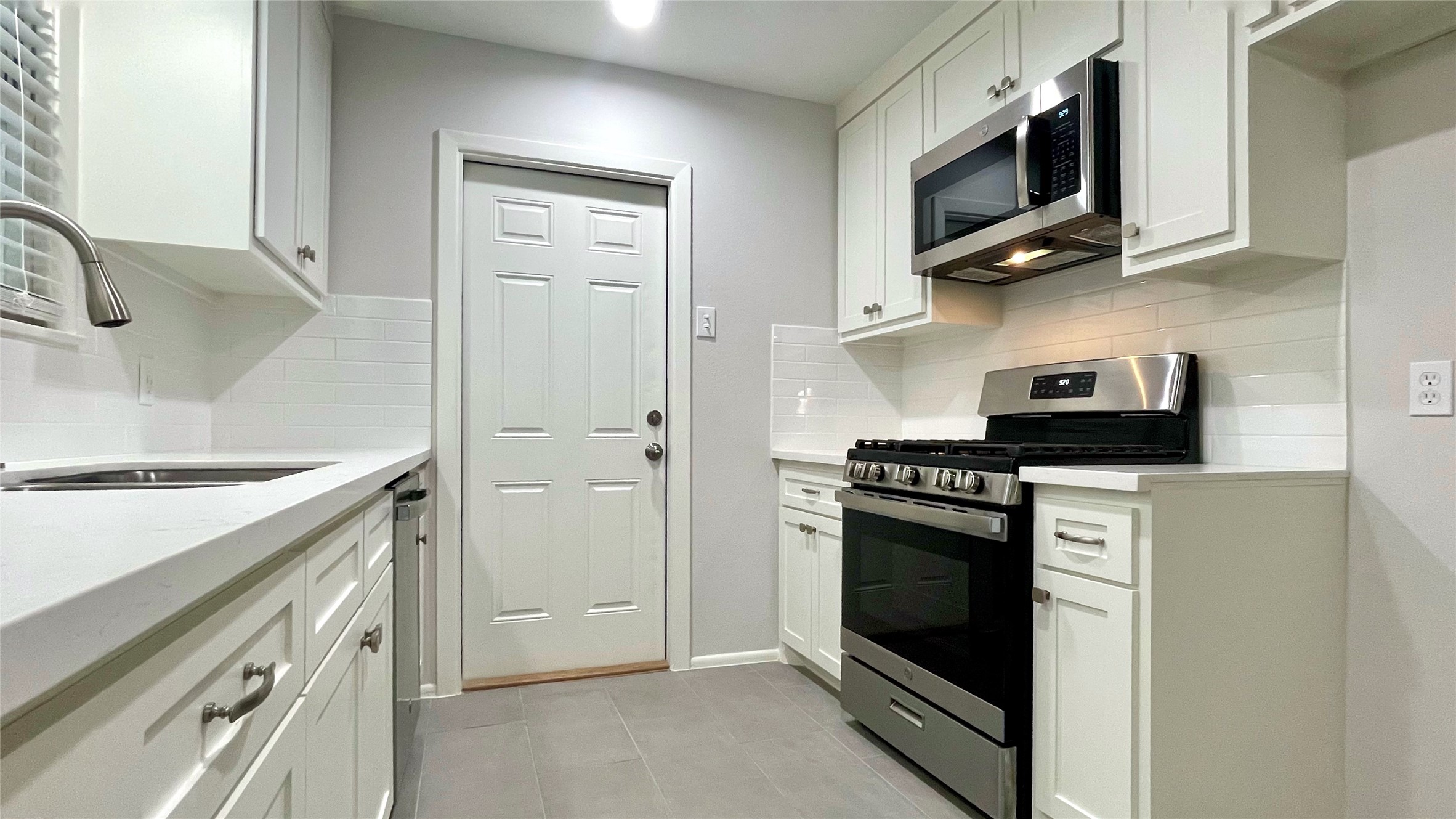 5905 Darnell Street Houston, TX 77074 - Photo 7 of 34 a kitchen with stainless steel appliances granite countertop a stove and a microwave