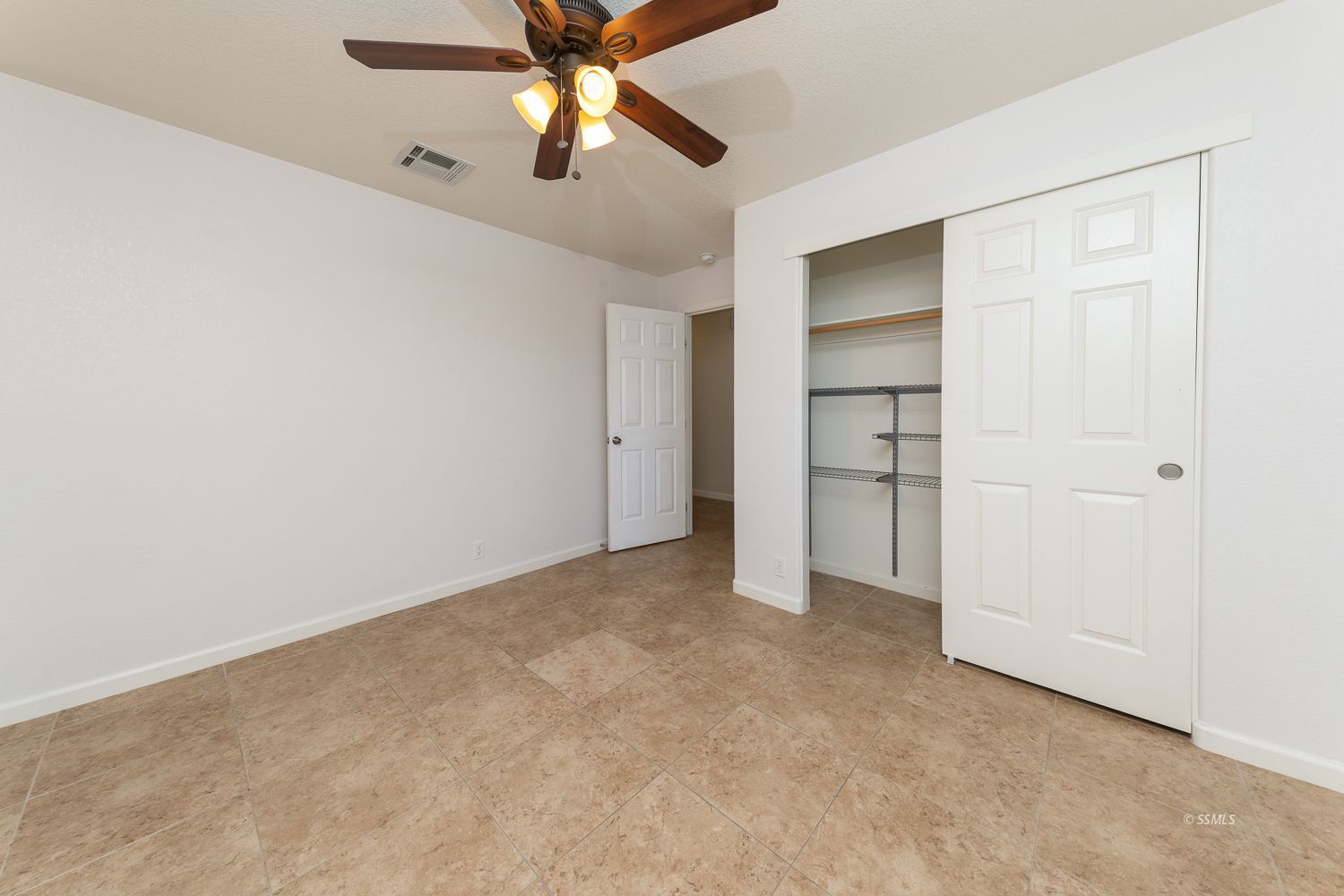 1009 Sims Street Ridgecrest, CA 93555 - Photo 11 of 40 an empty room with closet and a ceiling fan