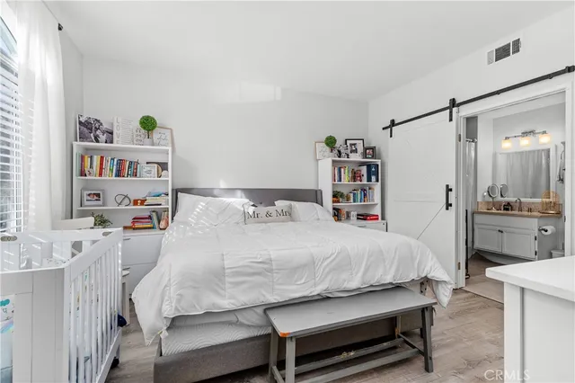 a bedroom with a bed and a book shelf
