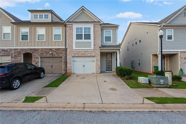 a front view of a house with a yard and garage