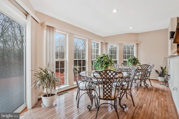a view of a dining room with furniture window and wooden floor