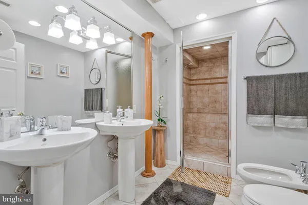 a spacious bathroom with a sink a toilet and shower