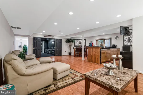 a living room with furniture and wooden floor