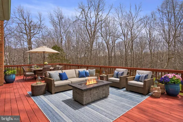 a outdoor living space with furniture and umbrella