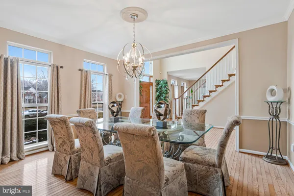 a view of a dining room with furniture wooden floor and chandelier
