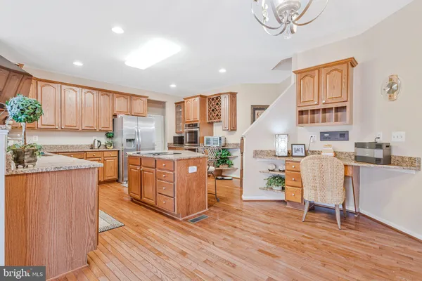 a kitchen with a table chairs refrigerator and cabinets