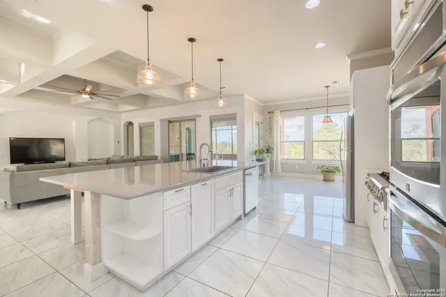 a large white kitchen with a large window