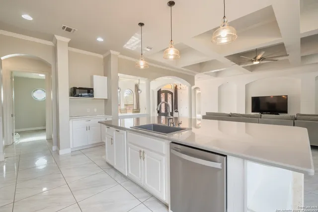 a large kitchen with kitchen island a sink and a refrigerator