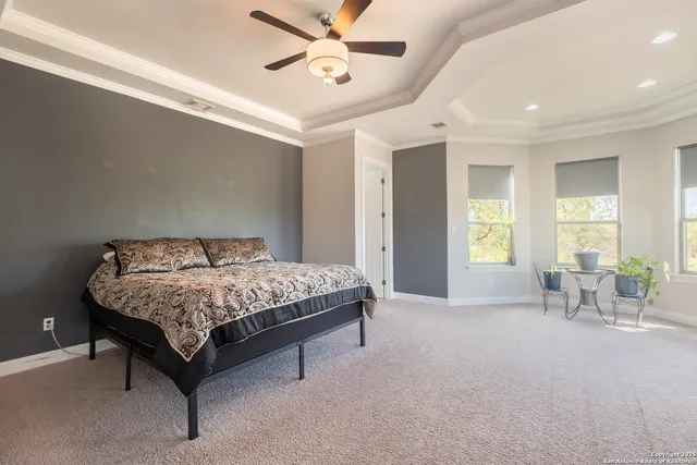 a bedroom with a bed a chandelier and a window