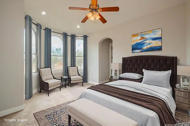 a bedroom with a large bed and a chandelier