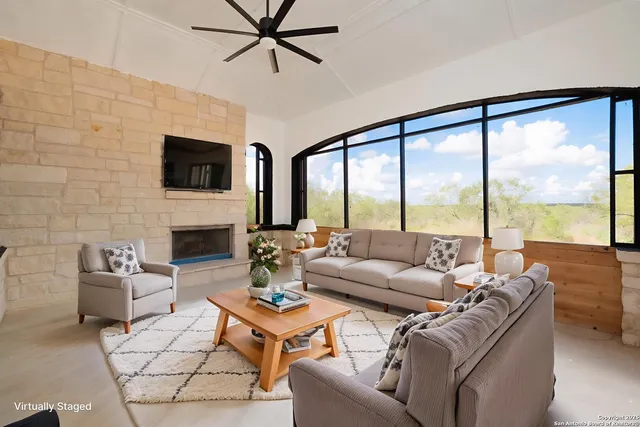 a living room with furniture a fireplace and a flat screen tv