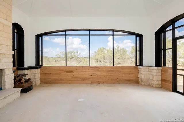 a living room with furniture and a floor to ceiling window