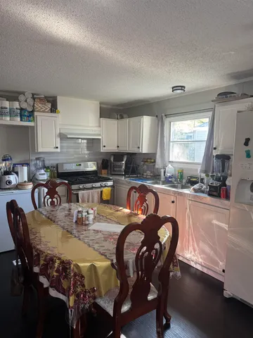 a kitchen with granite countertop a sink counter top space and stainless steel appliances