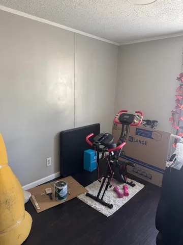 a room with furniture and gym equipment