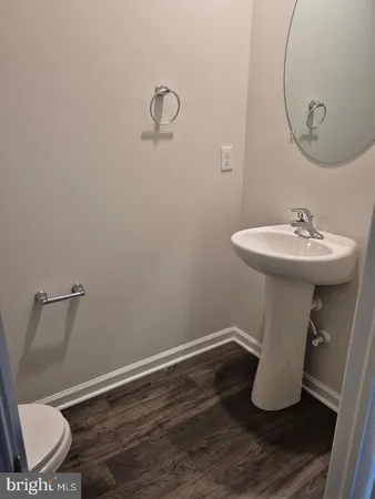 a white toilet and tub sitting next to a bathroom sink
