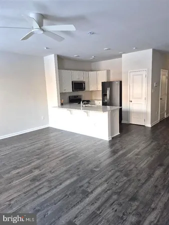 a kitchen with stainless steel appliances a refrigerator stove microwave and sink