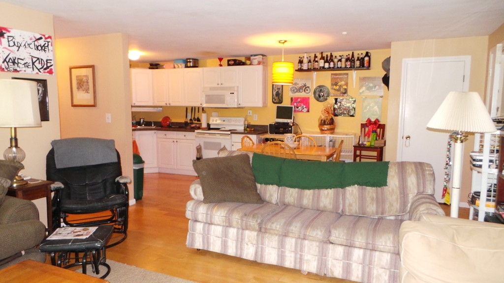 165 R Chestnut Street, Unit 8 Foxboro, MA 02035 - Photo 4 of 11 a living room with furniture and a lamp