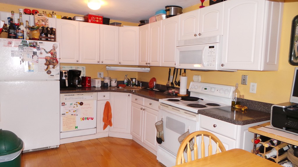 165 R Chestnut Street, Unit 8 Foxboro, MA 02035 - Photo 5 of 11 a kitchen with stainless steel appliances granite countertop a stove a sink and white cabinets