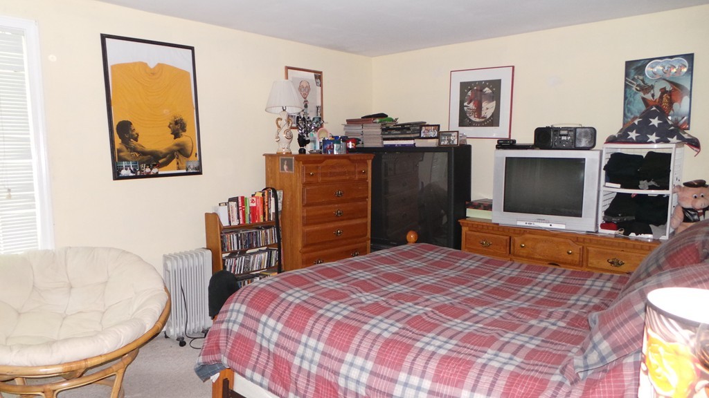 165 R Chestnut Street, Unit 8 Foxboro, MA 02035 - Photo 8 of 11 a bedroom with a bed and furniture