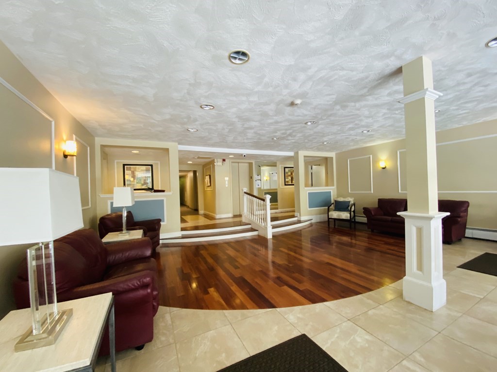 50 Green Street, Unit 209 Brookline, MA 02446 - Photo 11 of 16 a living room with furniture and a large window