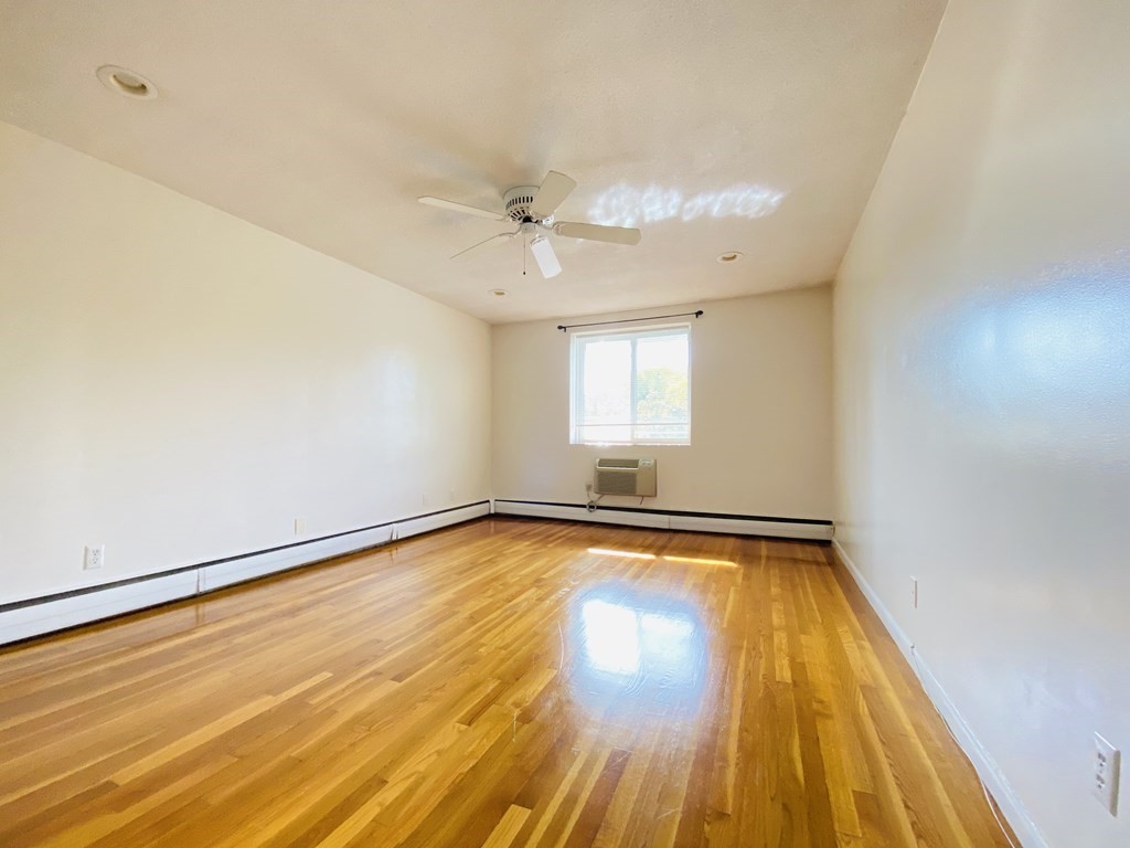 50 Green Street, Unit 209 Brookline, MA 02446 - Photo 5 of 16 a view of a room with wooden floor and fan