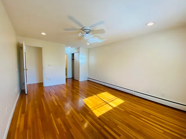 a view of a room with wooden floor