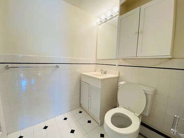 a white toilet sitting next to a bathroom sink