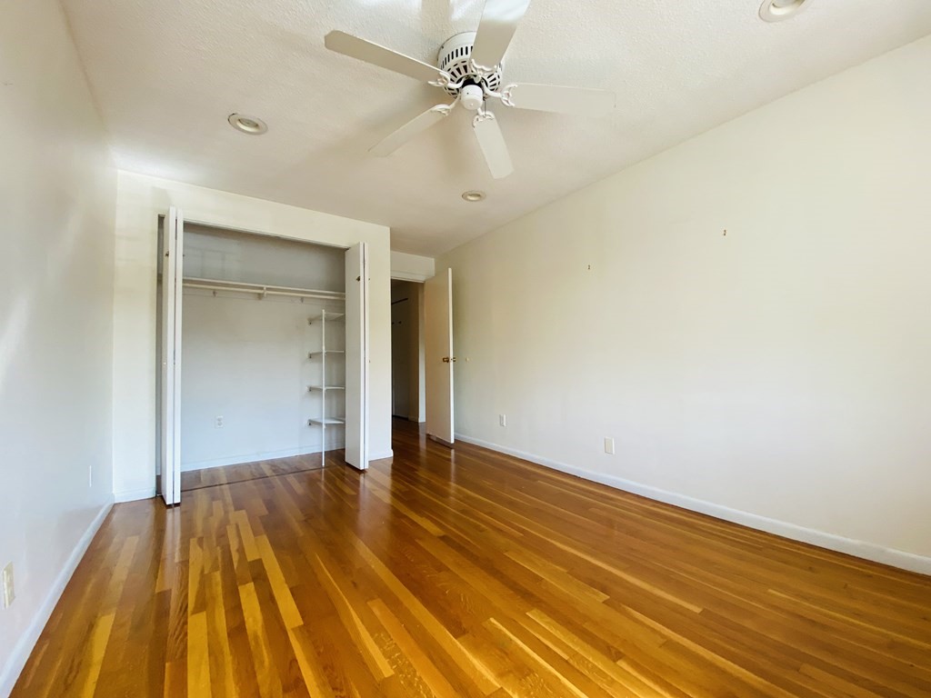 50 Green Street, Unit 209 Brookline, MA 02446 - Photo 9 of 16 wooden floor in an empty room