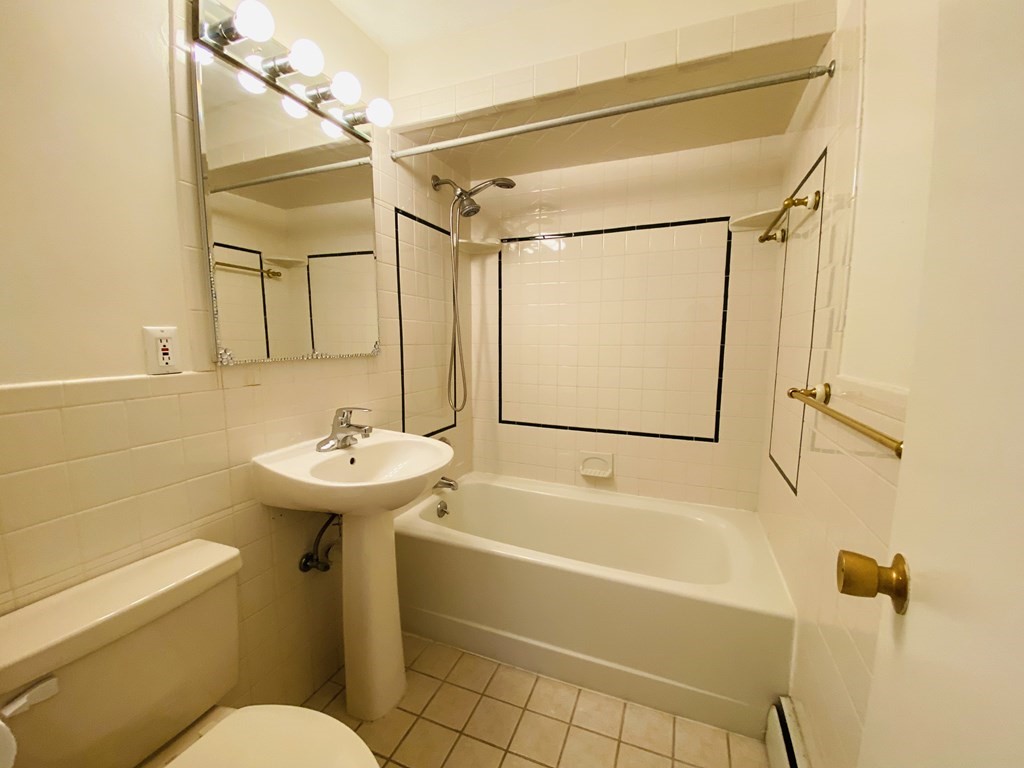 50 Green Street, Unit 209 Brookline, MA 02446 - Photo 10 of 16 a bathroom with a sink a toilet and shower