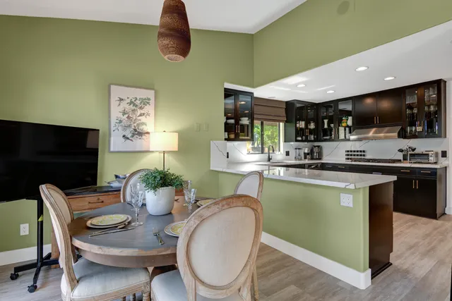 a dining room with furniture and a kitchen view