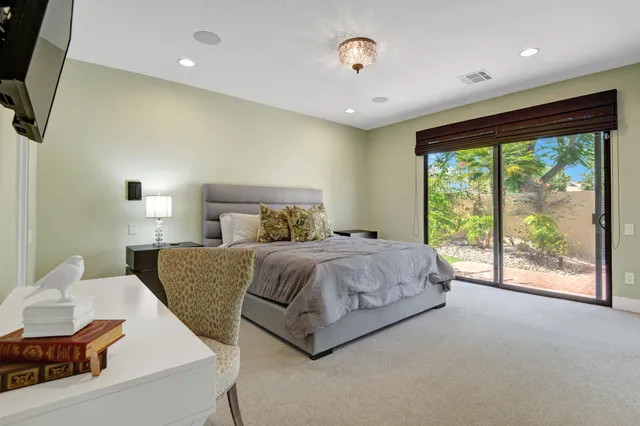 a bedroom with a large bed and a large window