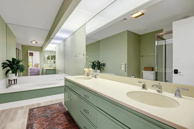 a spacious bathroom with a sink and a mirror