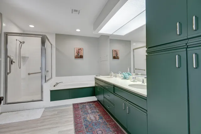 a bathroom with a tub sink and mirror