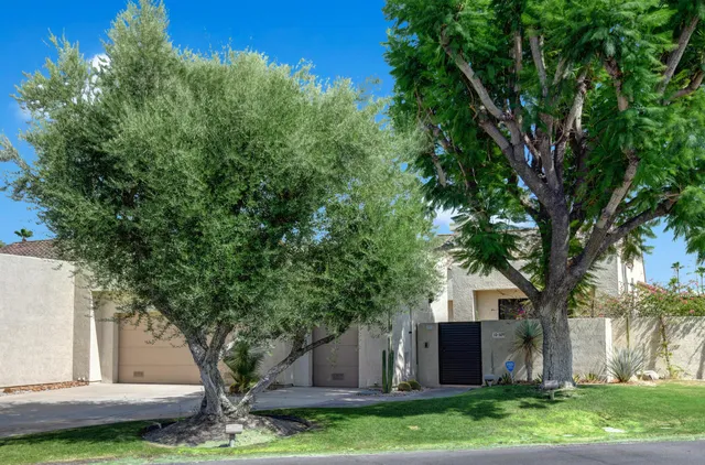 a view of a patio with table and chairs with wooden floor and fence