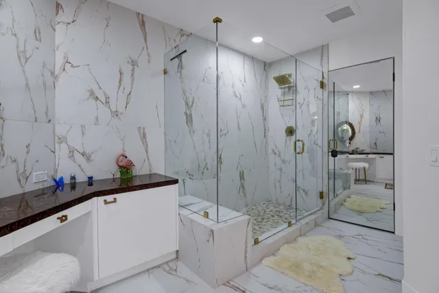 a bathroom with a shower sink and mirror