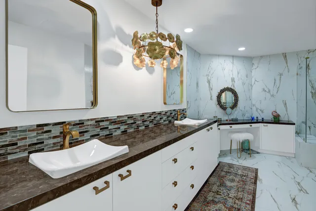 a bathroom with a granite countertop sink and a mirror