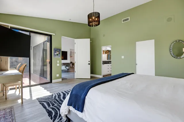 a bedroom with a bed and a chandelier