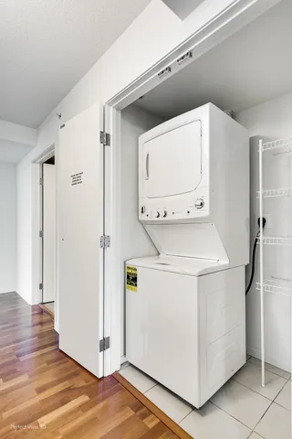a utility room with cabinets washer and dryer