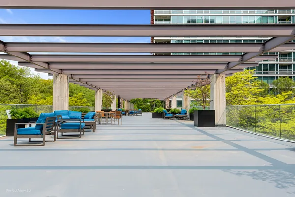 a building outdoor space with patio furniture and potted plants