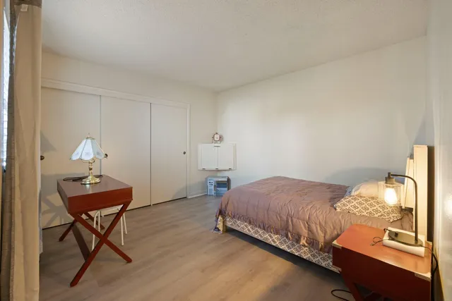 a bedroom with a bed and a lamp on table