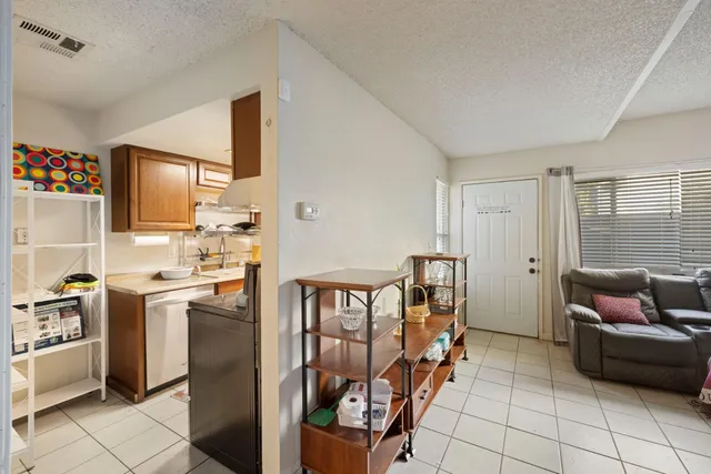 a living room with stainless steel appliances furniture and a window