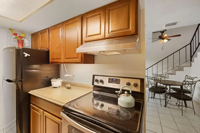 a kitchen with appliances cabinets and furniture