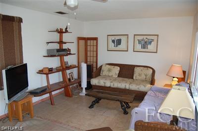 5871 Tarpon Road Bokeelia, FL 33922 - Photo 3 of 8 a living room with furniture and a flat screen tv