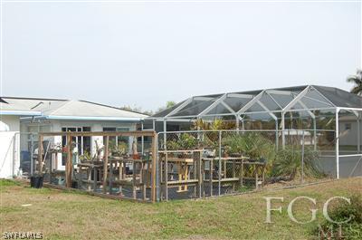 5871 Tarpon Road Bokeelia, FL 33922 - Photo 7 of 8 a view of a house with a backyard
