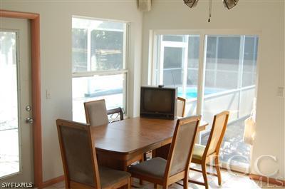 5871 Tarpon Road Bokeelia, FL 33922 - Photo 8 of 8 a view of a dining room with furniture window and outside view
