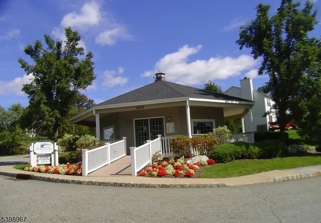 a front view of a house with a yard garage and outdoor seating