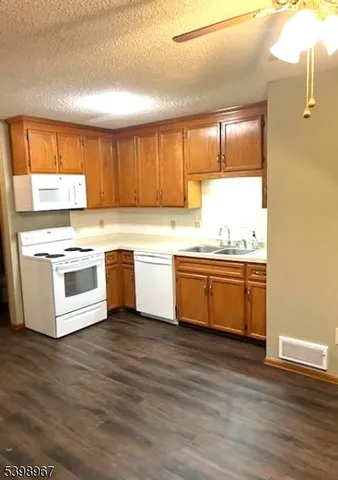 a kitchen with stainless steel appliances a white stove top oven sink and window