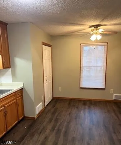 a view of a room with wooden floors and cabinet